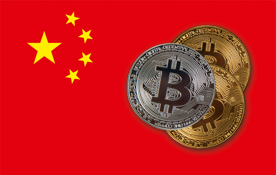 Bitcoin coins on red China flag