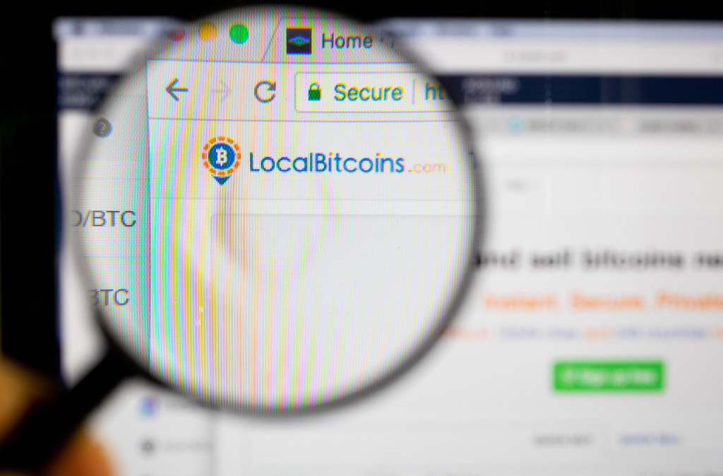 Localbitcoins logo on a computer screen with a magnifying glass