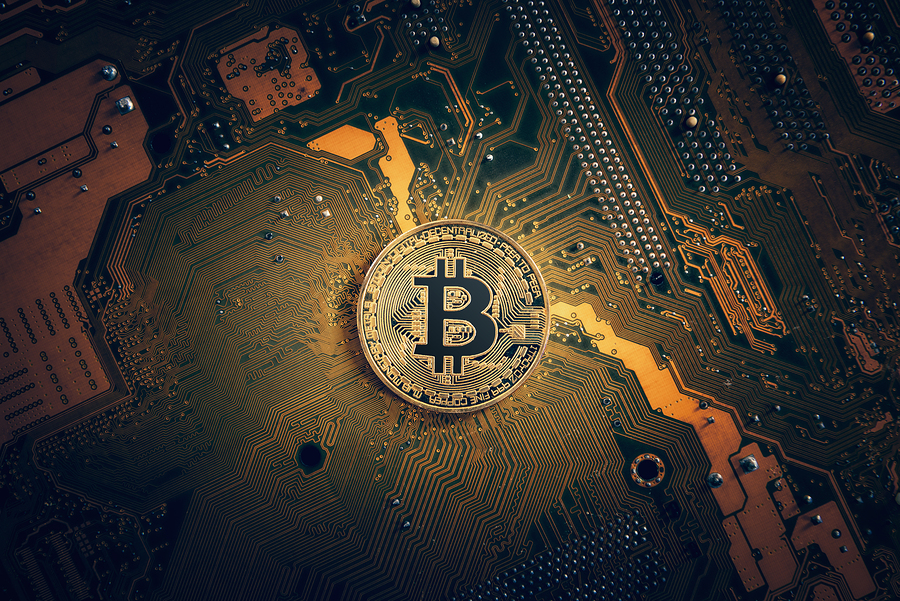 Golden Bitcoin Cryptocurrency On Computer Electronic Circuit Boa